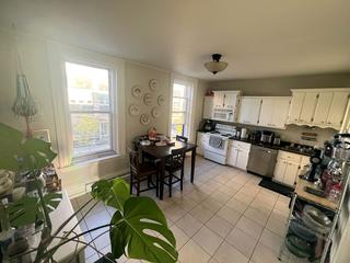 Kitchen with white cabinets and dining area