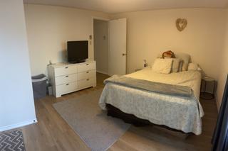 Bedroom with dresser and bed