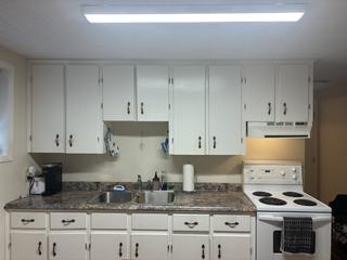 Kitchen counter with sink and white cabinets