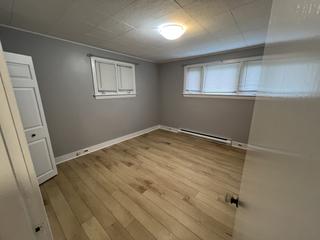 Second main-floor bedroom with a closet and large windows