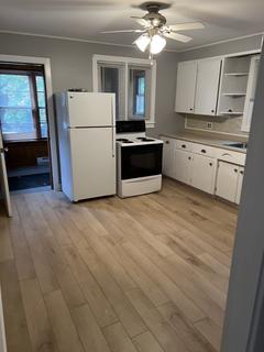Kitchen with ceiling fan and a doorway to the sunroom