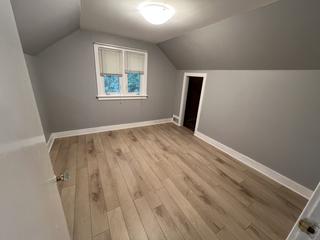 Upstairs room with a sloped ceiling